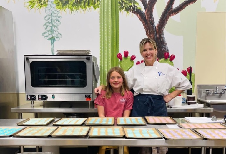 A photo of a woman and girl in a kitchen